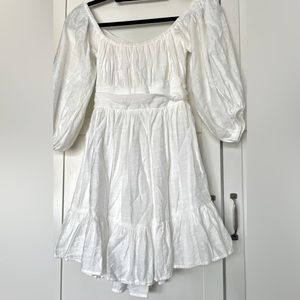 Saints + Secrets coquette dress color white.